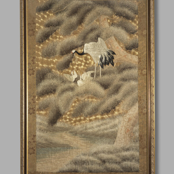Embroidered wall hanging with cranes amongst pine trees