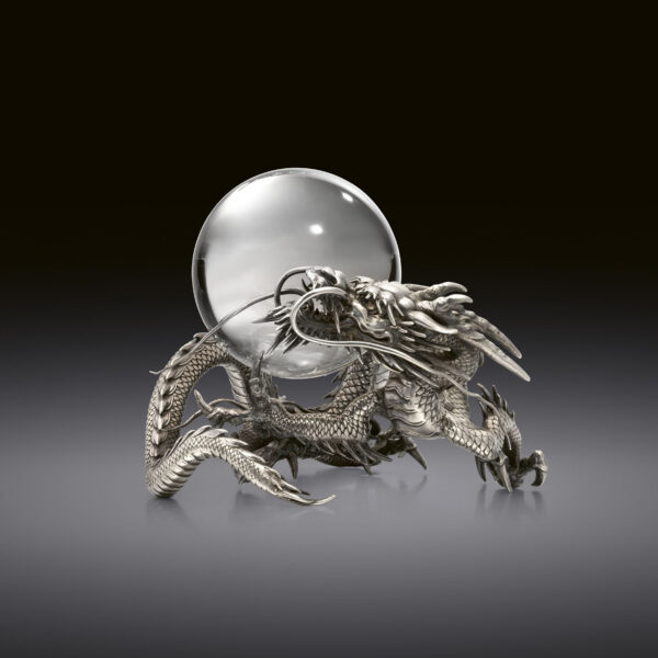 Silver okimono of dragon with a crystal ball
